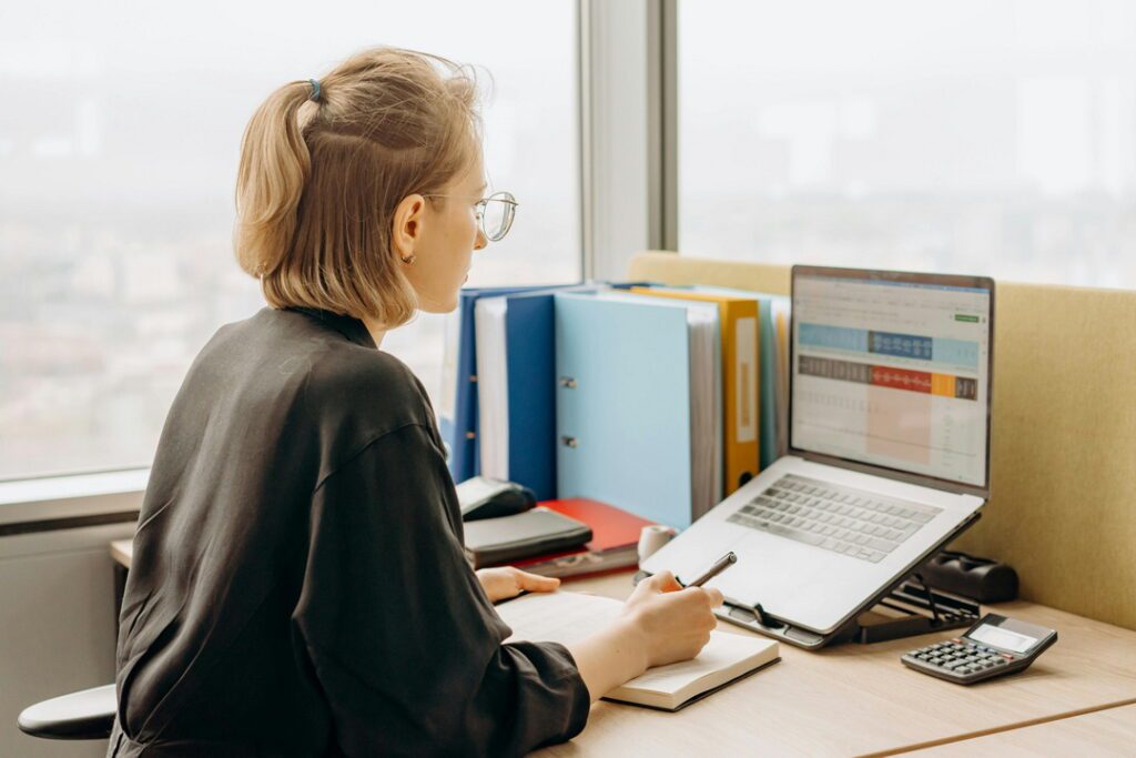 A photo of a woman working with a laptop